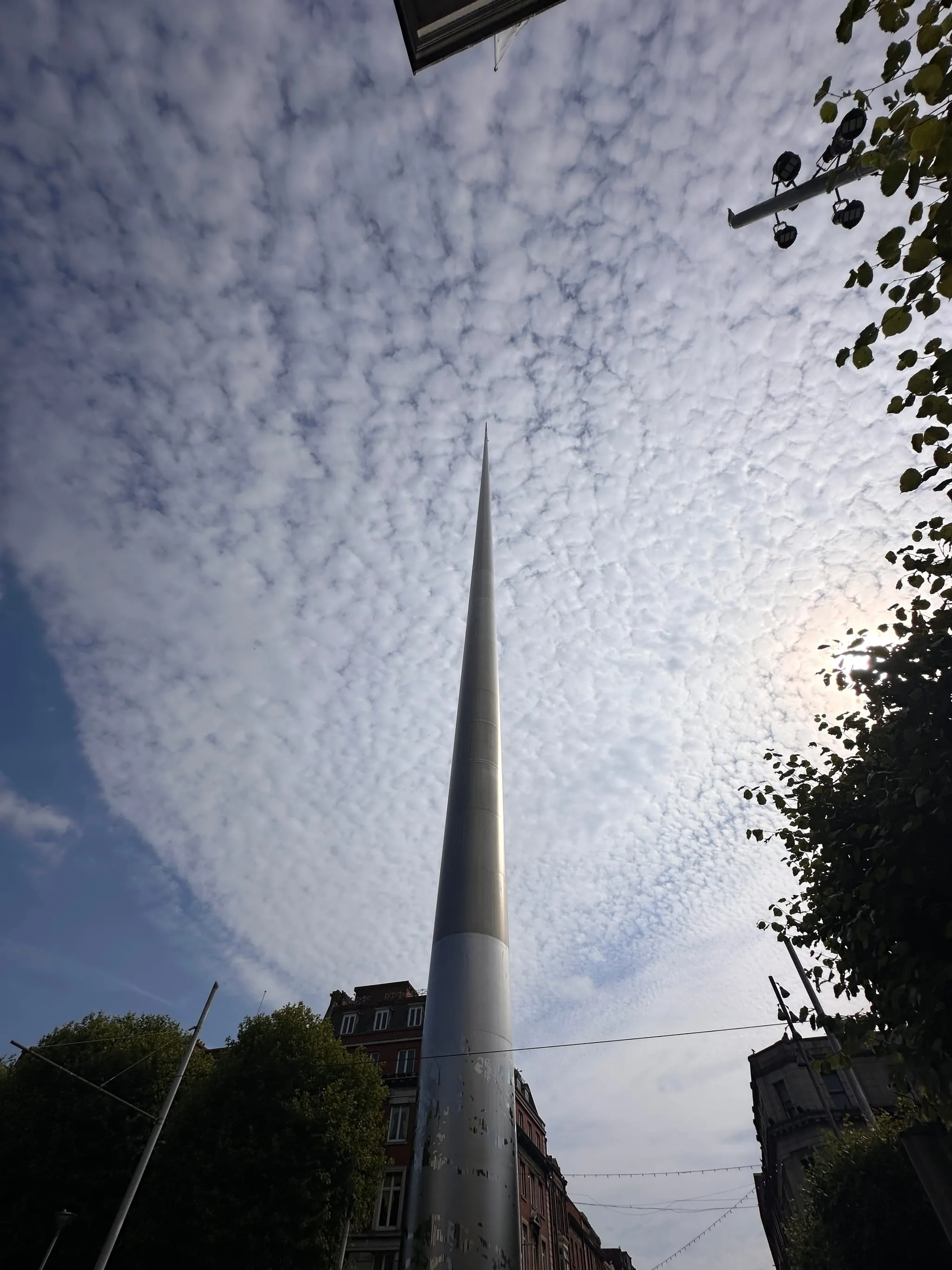 The Spire of Dublin on O'Connell Street, seen from below against a mackerel sky